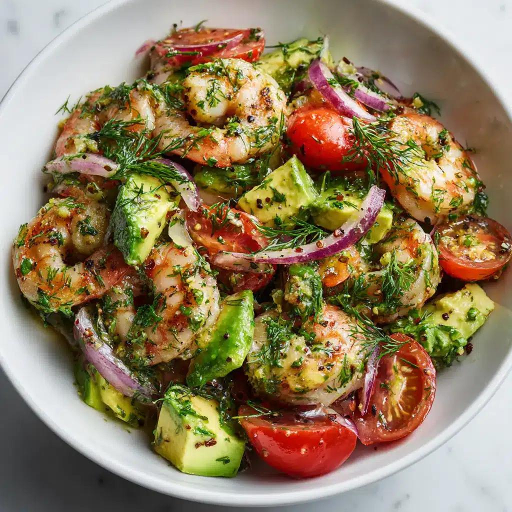 A close-up of the key ingredients for shrimp avocado salad: cooked shrimp, diced avocado, and red onion.