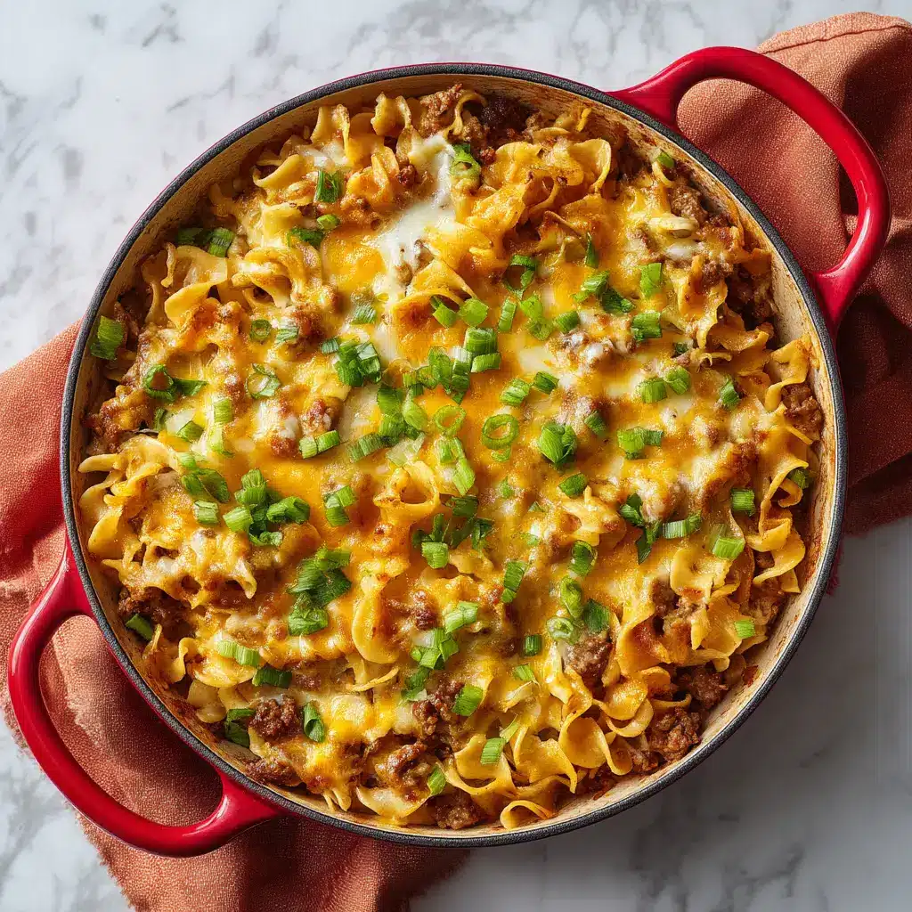 The Ultimate Cheesy Ground Beef Casserole Recipe 2 Close up food texture of a thick layer of golden brown melted cheddar and white cheese over a ground beef casserole.