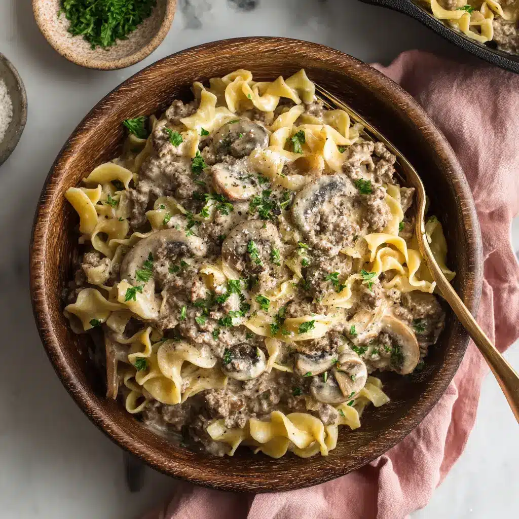 Ground Beef Stroganoff garnished with freshly chopped green parsley, sitting on a white marble surface with a pink linen napkin.