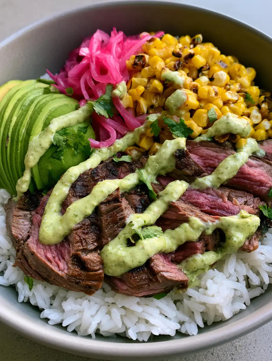 Handheld photo showing the juicy texture of medium-rare sirloin steak slices in a Steak and Avocado Rice Bowl.