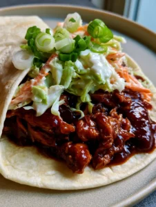 Close up of the textured filling inside the BBQ Chicken Coleslaw Wraps on a matte ceramic plate.