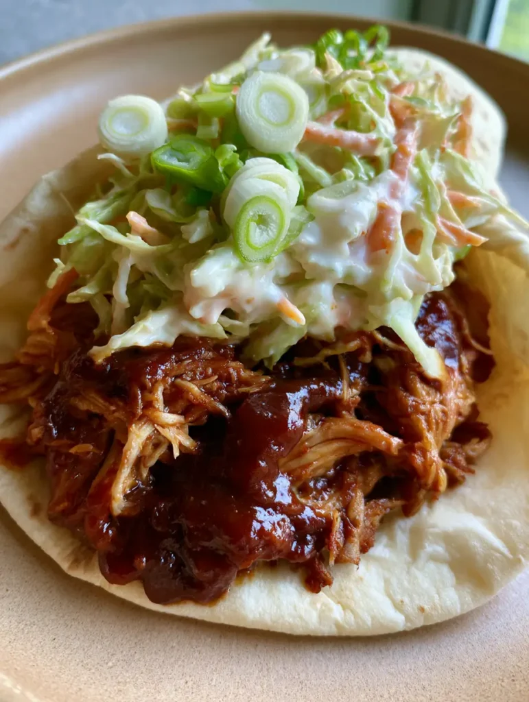 Side view of BBQ Chicken Coleslaw Wraps highlighting the crisp cabbage and orange carrots.
